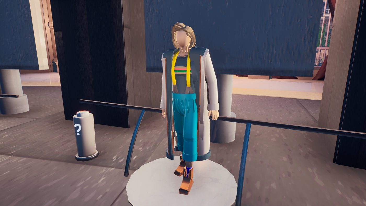 The Thirteenth Doctor's costume on a plinth: long coat, rainbow-striped shirt and cropped trousers